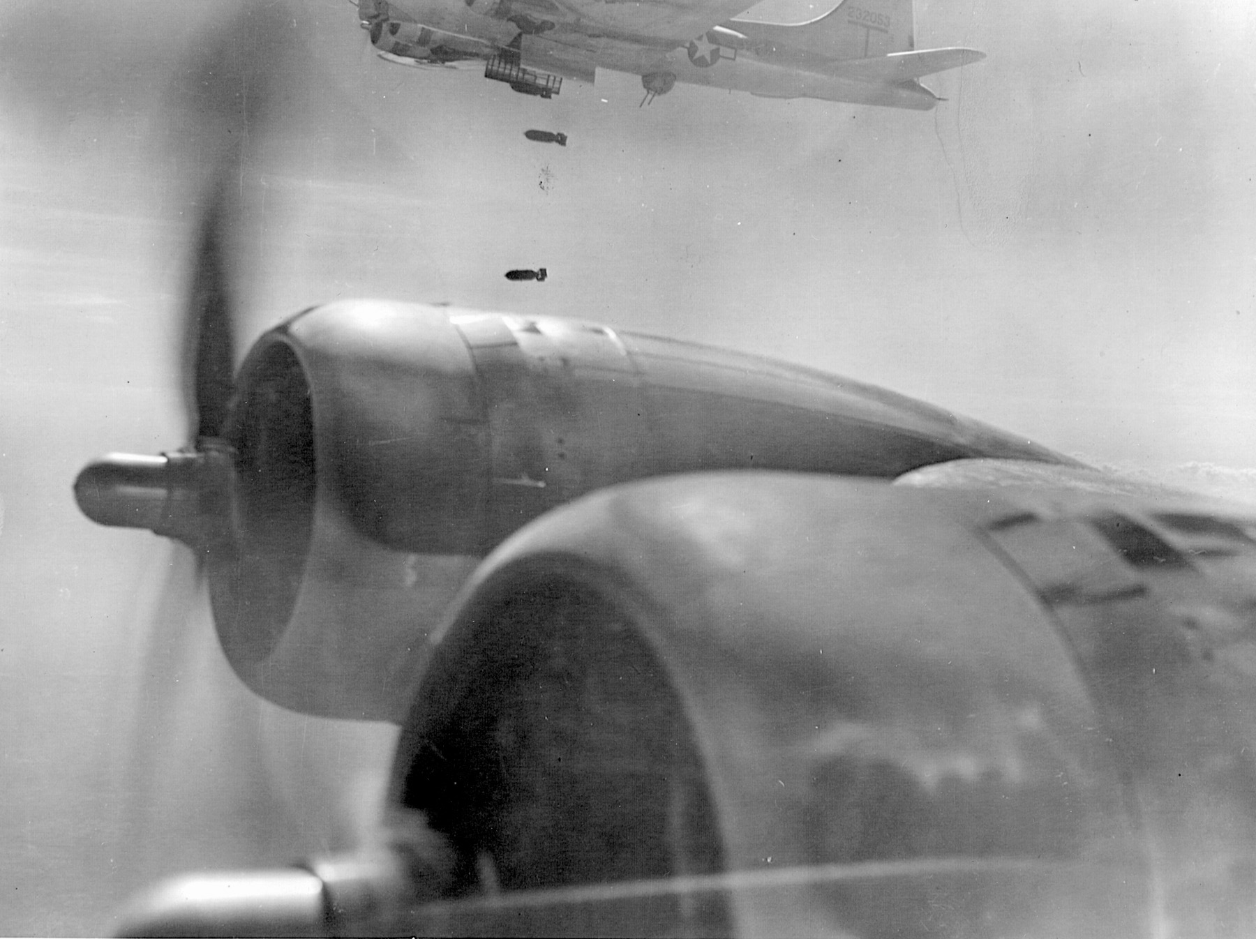 American B-17s drop bombs on an enemy target during the return flight to bases in Italy.