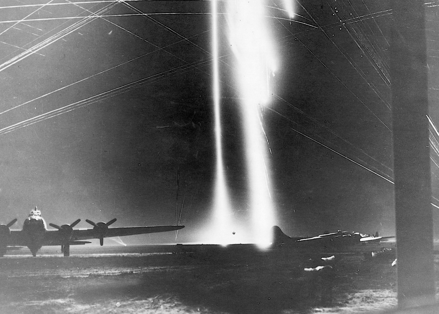 Antiaircraft fire and flares light up the night sky during a German raid on American shuttle bases in Russia.