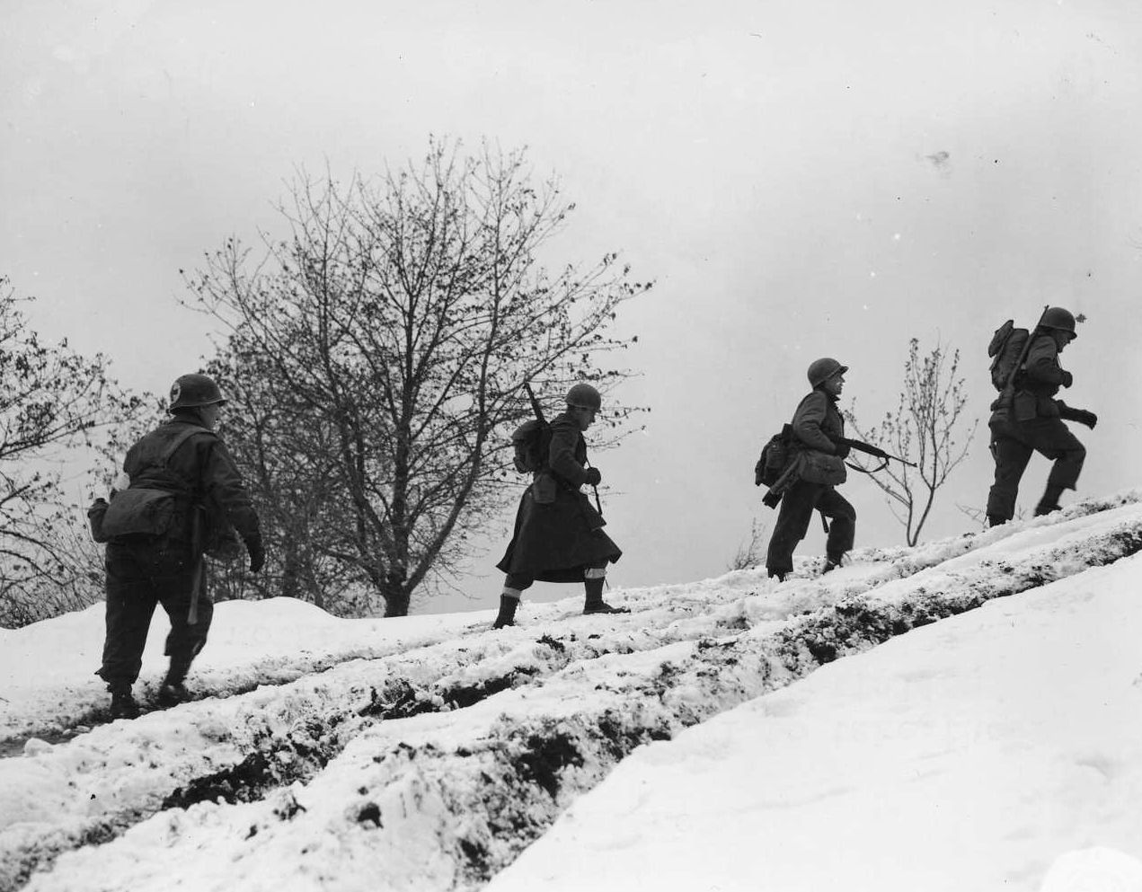 Carrying their weapons and heavy equipment, American soldiers trudge up a steep incline toward frontline positions. Although it has been overshadowed by the fighting in the Bulge, the combat in Southern France was nevertheless ferocious. 
