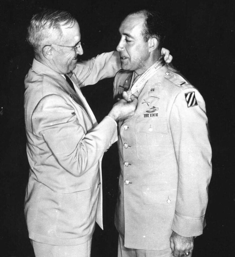 The shoulder patch of the 3rd Infantry Division prominently visible on his uniform, First Lieutenant Eli Whiteley receives the Medal of Honor for his heroism on Hill 351. President Harry S. Truman presents the medal on August 23, 1945.