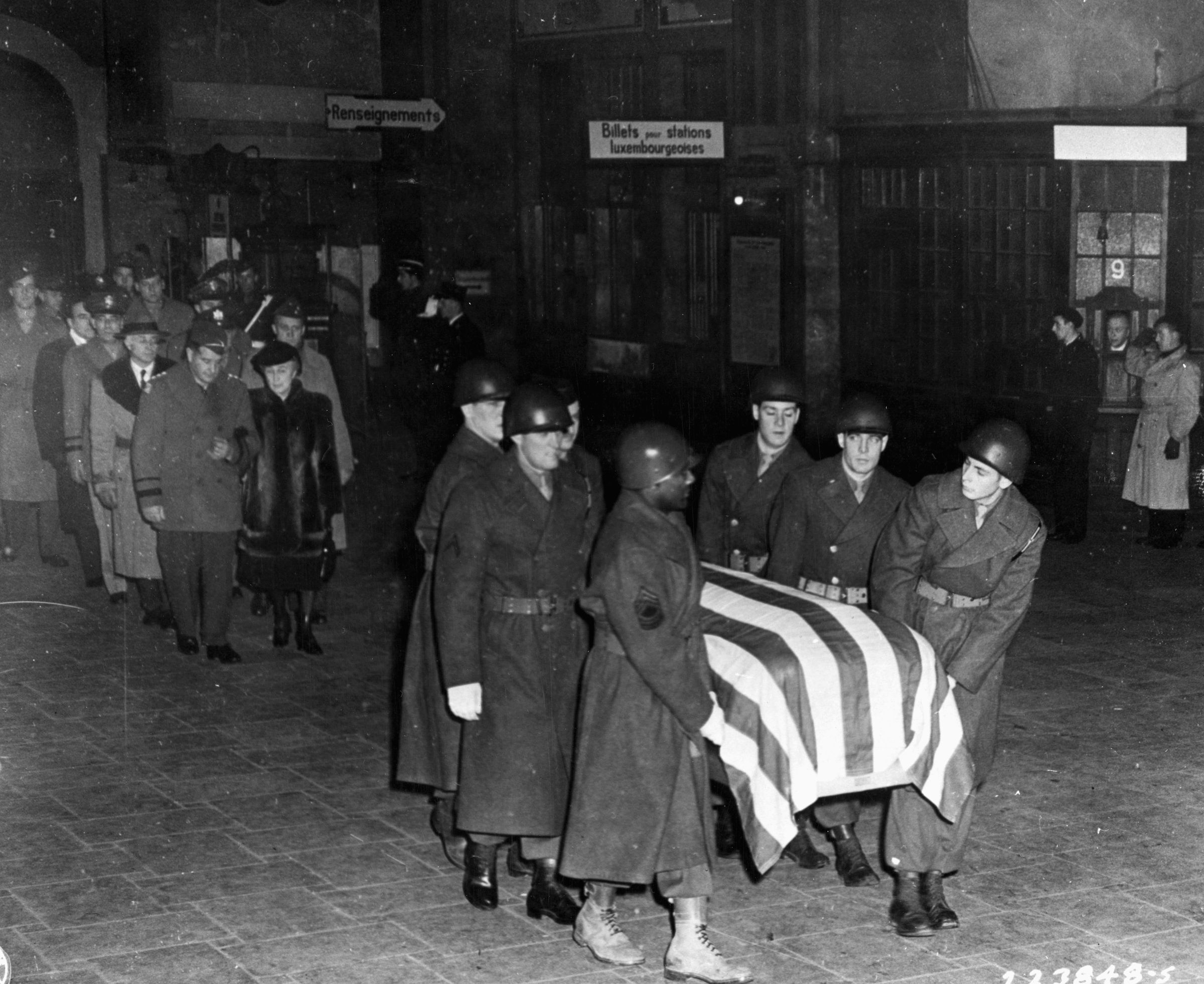 General Patton’s wife, Beatrice, follows his casket through the train station in Luxembourg City en route to the nearby cemetery in Hamm.