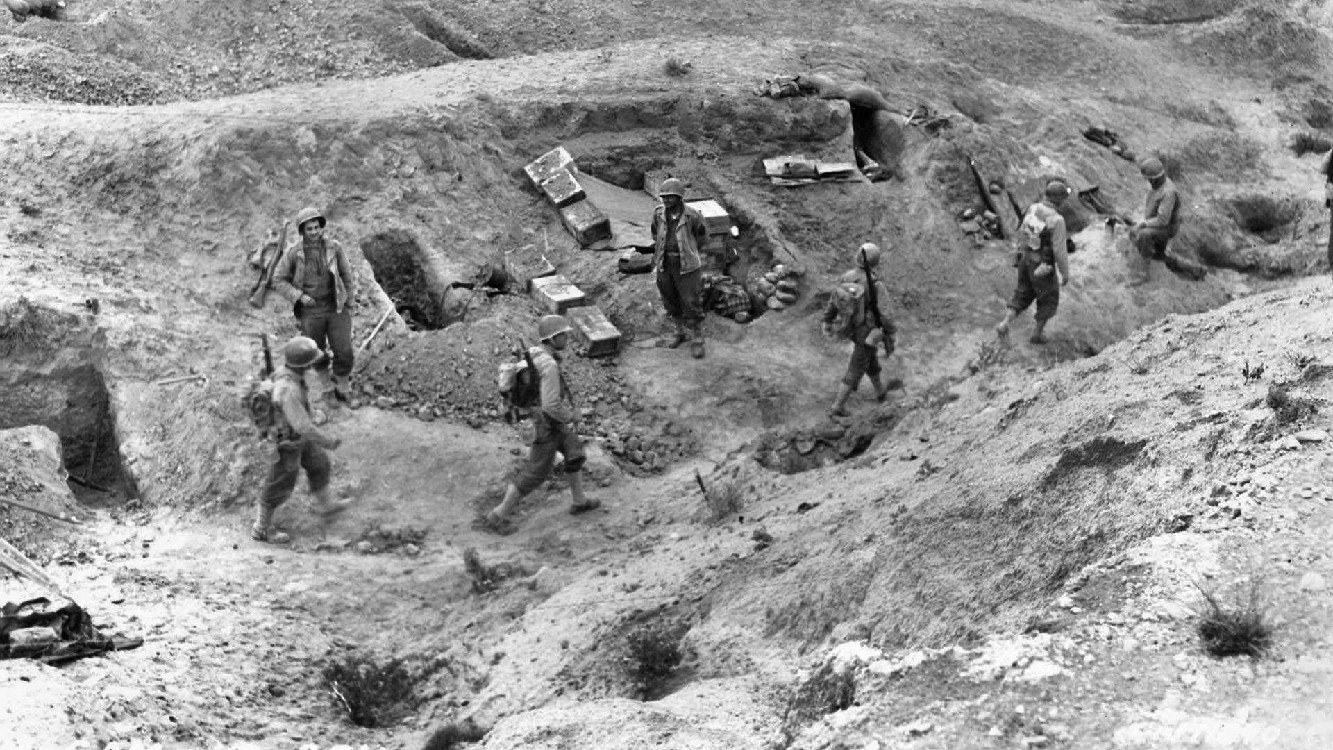 Soldiers of the U.S. 1st Infantry Division dig in near El Guettar, where they went into action against the German 10th Panzer Division and won. The 1st Division was a crack combat unit, molded under the leadership of Generals Allen and Roosevelt.