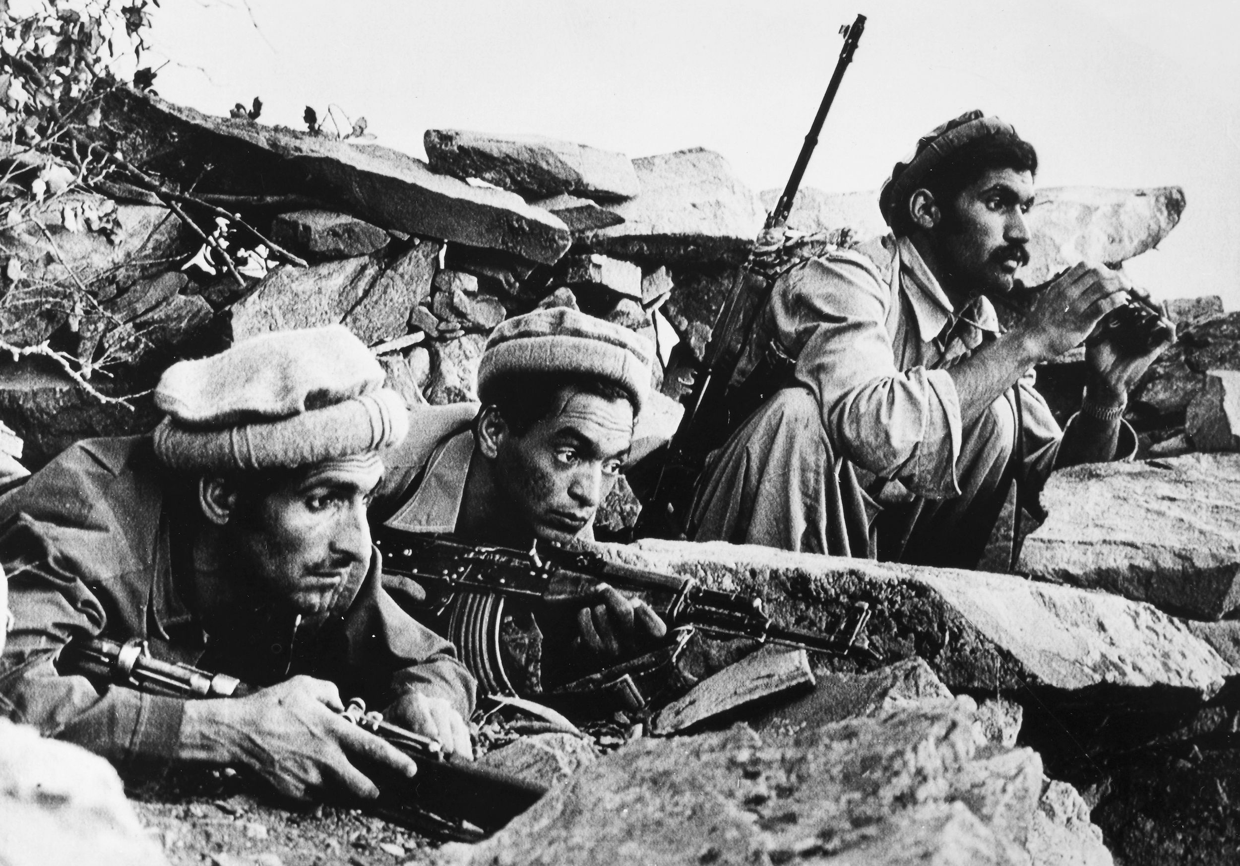 Sharp-eyed Muslim snipers perch on a hilltop overlooking a government encampment at Barikot in Kunar Province, September 1979.