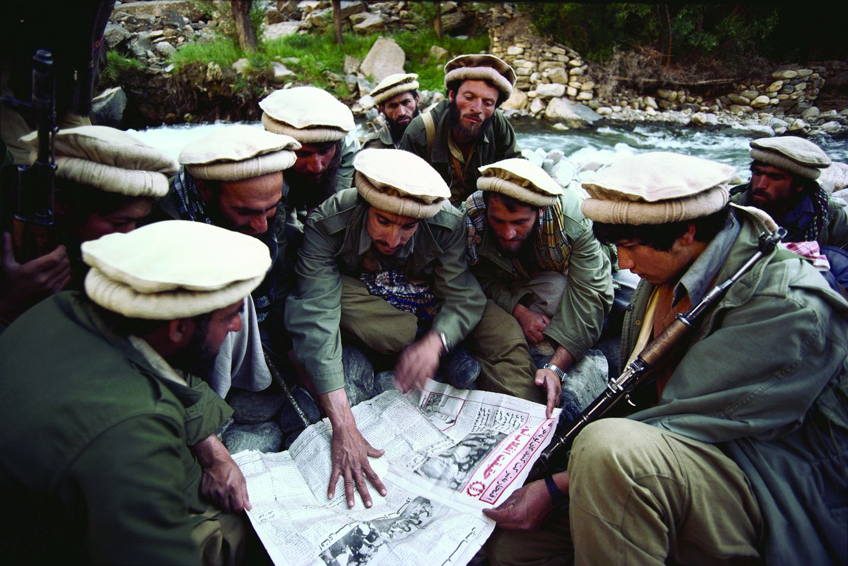 Ahmad Shah Massoud, the most feared Afghan guerrilla leader, goes over a chart with his commanders in Bagram, April 1985. Massoud was assassinated by Muslim radicals two days before 9/11. 