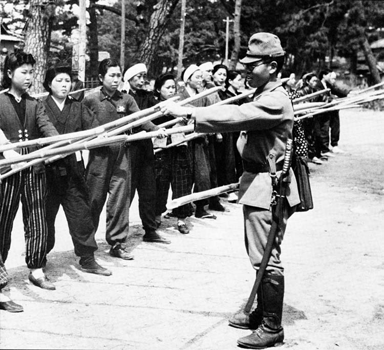 Everyone was enlisted in the defense of the Japanese homeland. Here, an officer of the Japanese Army instructs a group of housewives in the use of bamboo spears.