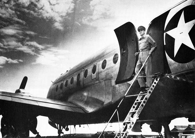 General Douglas MacArthur, leader of the Allied forces occupying Japan, steps down from his C-54 transport aircraft, Bataan, at Atsugi airfield near the city of Yokohama. The U.S. 11th Airborne Division had secured the area only days earlier.