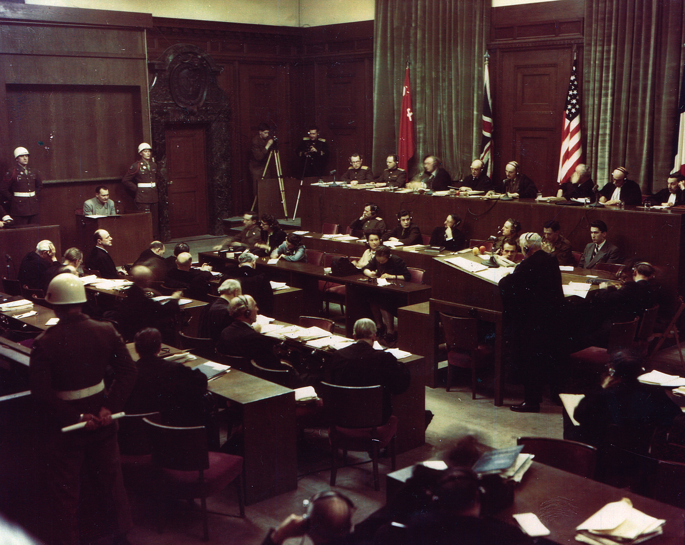 Göring, seated on the witness stand, is addressed by Dr. Otto Stahmer at the podium.