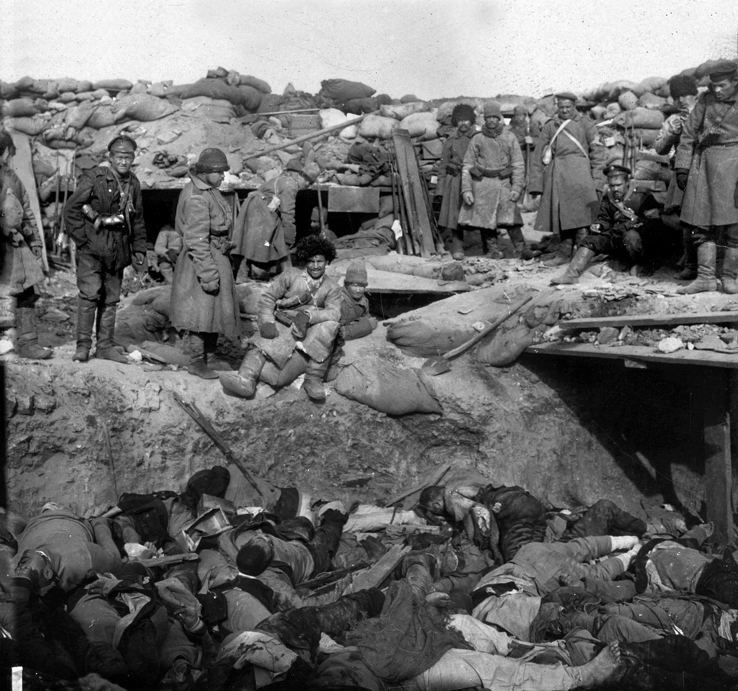 Russian defenders loom over a trench filled with dead Japanese soldiers. The “banzai spirit” cost the Japanese greatly.