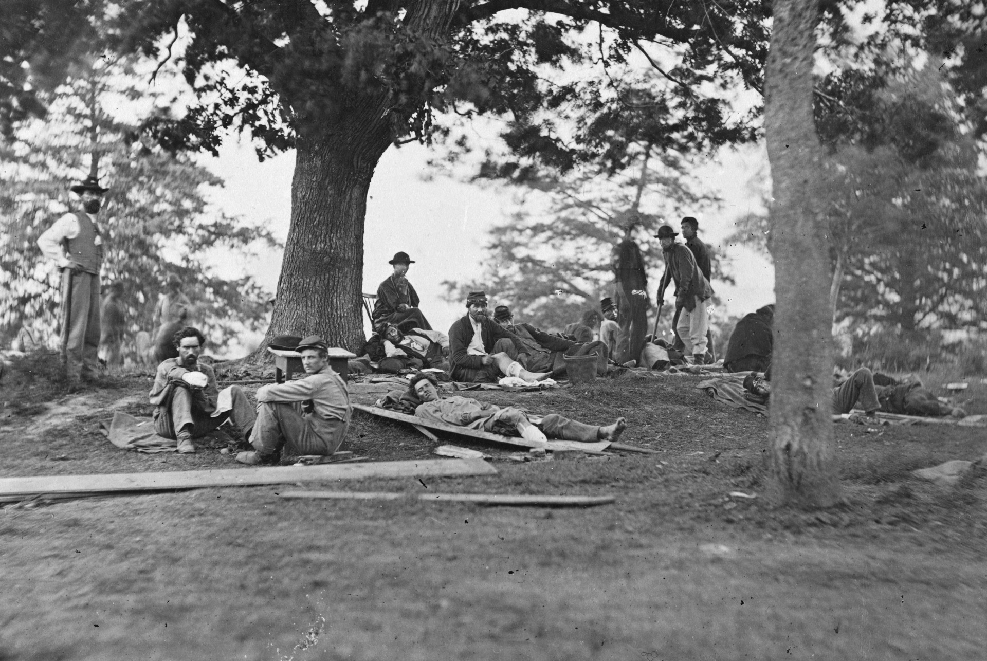 Wounded soldiers on the grass outside a field at Fredericksburg, Virginia. Many of the wounded would end up in hospitals in Washington, where they either recuperated or died.