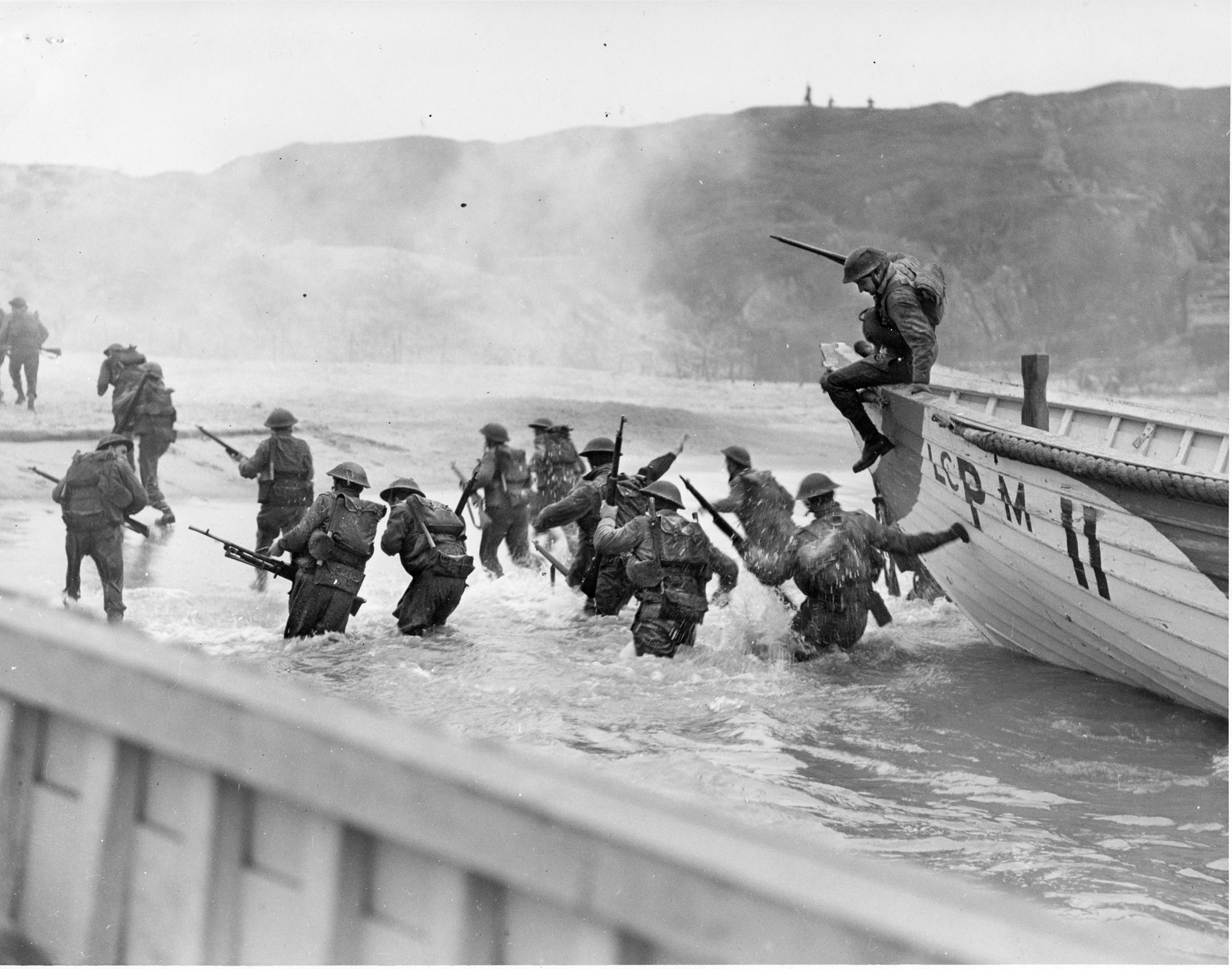 Canadian troops rehearse for Operation Overlord at the Slapton Sands training area in Devon, England. They are disembarking from wooden lifeboats rather than the military landing craft they will come ashore in on D-Day.