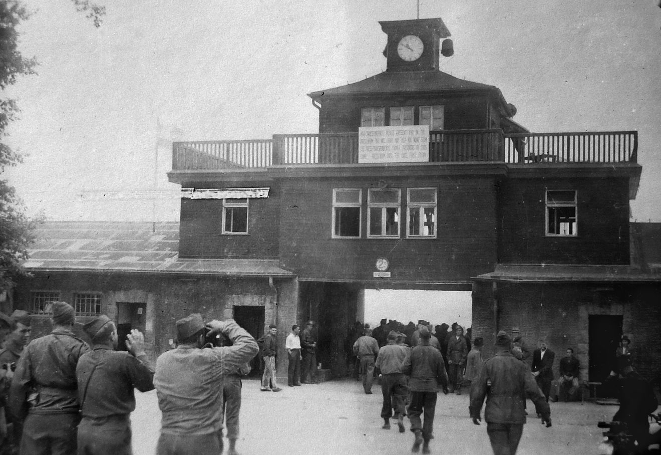 After the Allies began uncovering concentration camps, General Eisenhower directed that as many units as possible visit Buchenwald, outside of Weimar, to bear witness to Nazi atrocities. My father and other officers visited the camp in late May or early June of 1945. Here the visitors are snapping photos of Buchenwald’s main gate.