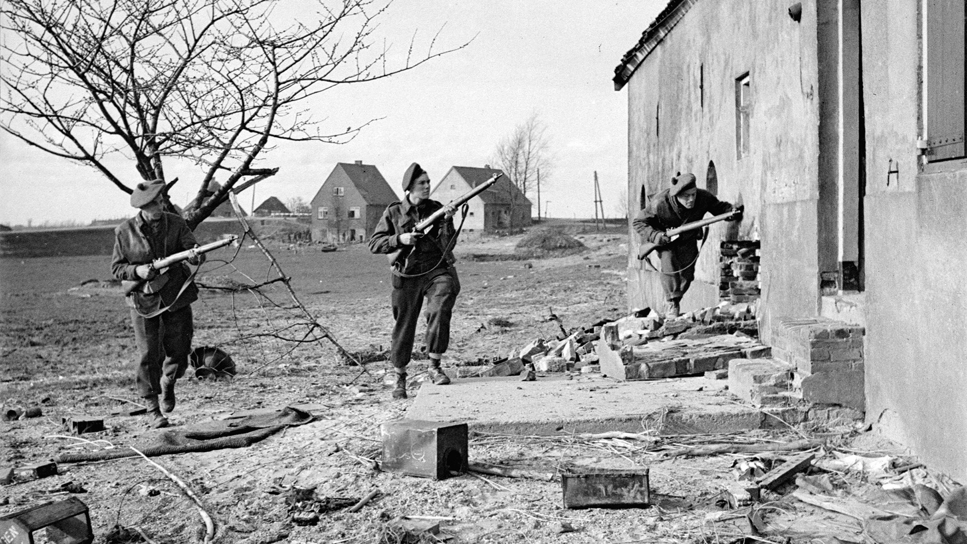 Canadian soldiers clear a group of buildings on the outskirts of a town in France. Canadian troops were involved in heavy fighting with Field Marshal Bernard L. Montgomery’s 21st Army Group during the Normandy campaign and beyond.