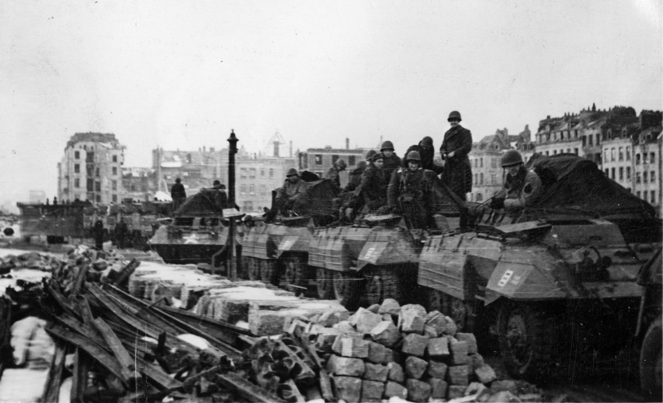 The 809th Tank Destroyer Battalion prepares to move out from the French port of Le Havre on January 22, 1945. The equipment consists of M20 command and reconnaissance cars belonging to the 809th’s A Company. The M20 was a variant of the M8 Greyhound, with the turret and 37mm cannon removed.