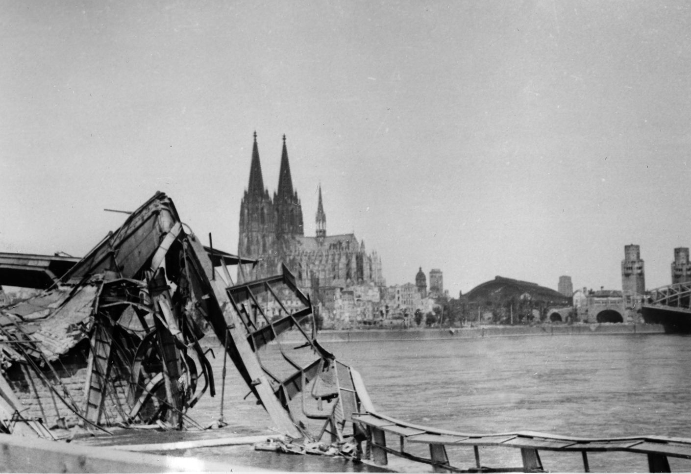 Cologne was bombed 262 times during the war. This photograph (looking west) shows a destroyed bridge over the Rhine River with the Cologne Cathedral (built between 1248 and 1880) in the background. The cathedral was, and is, the largest Gothic cathedral in northern Europe. Although the cathedral did sustain damage, it was not destroyed and was restored in 1956.