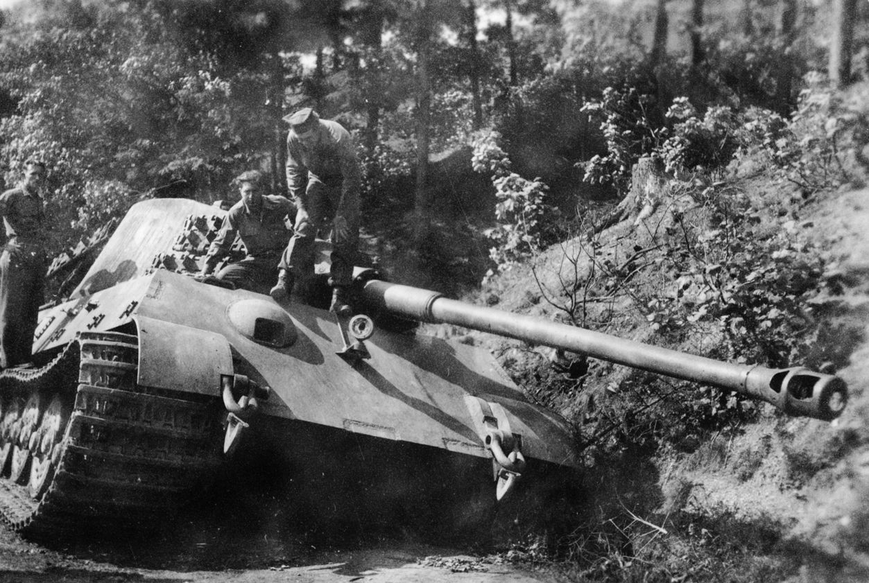 Three GIs inspect a Panzerkampfwagen Tiger Ausf. B (King Tiger, or Königstiger) heavy tank, disabled in the Harz Mountains of north-central Germany near the town of Schierke. Photographed on April 29, 1945. 