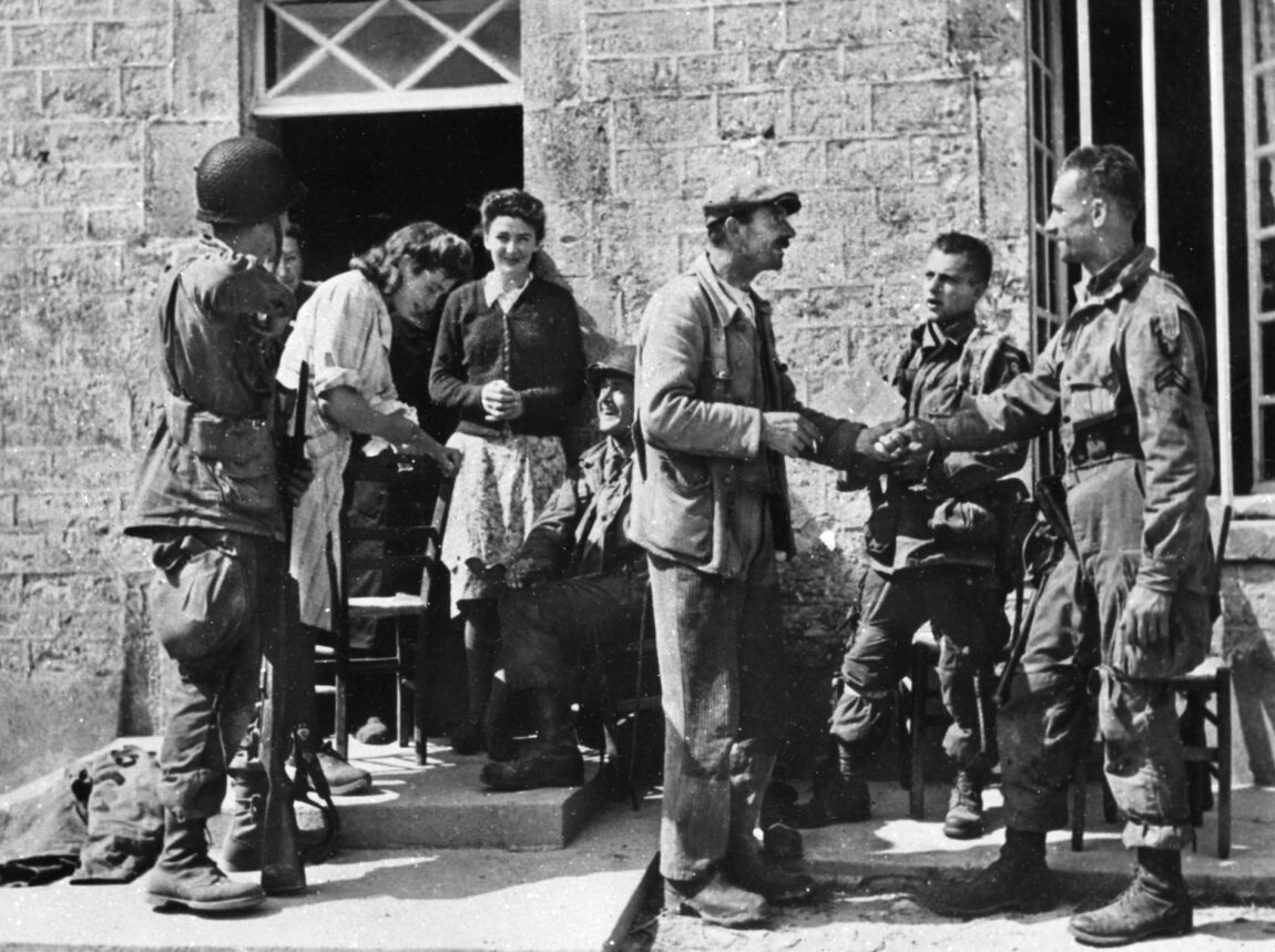French civilians bring out chairs for troops of the 82nd and 101st Airborne Divisions to enjoy.