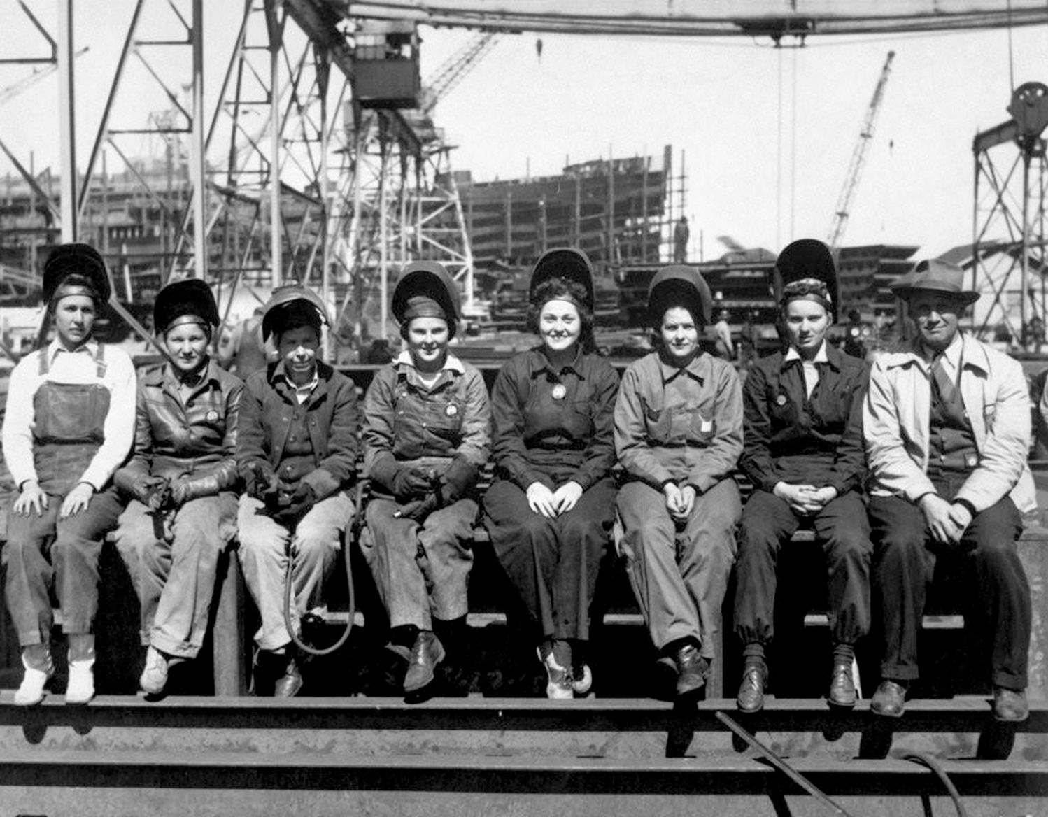Women working in traditionally all-male occupations were a popular subject for photographers. Here a female welding crew and their male supervisor pose at an unidentified American shipyard.