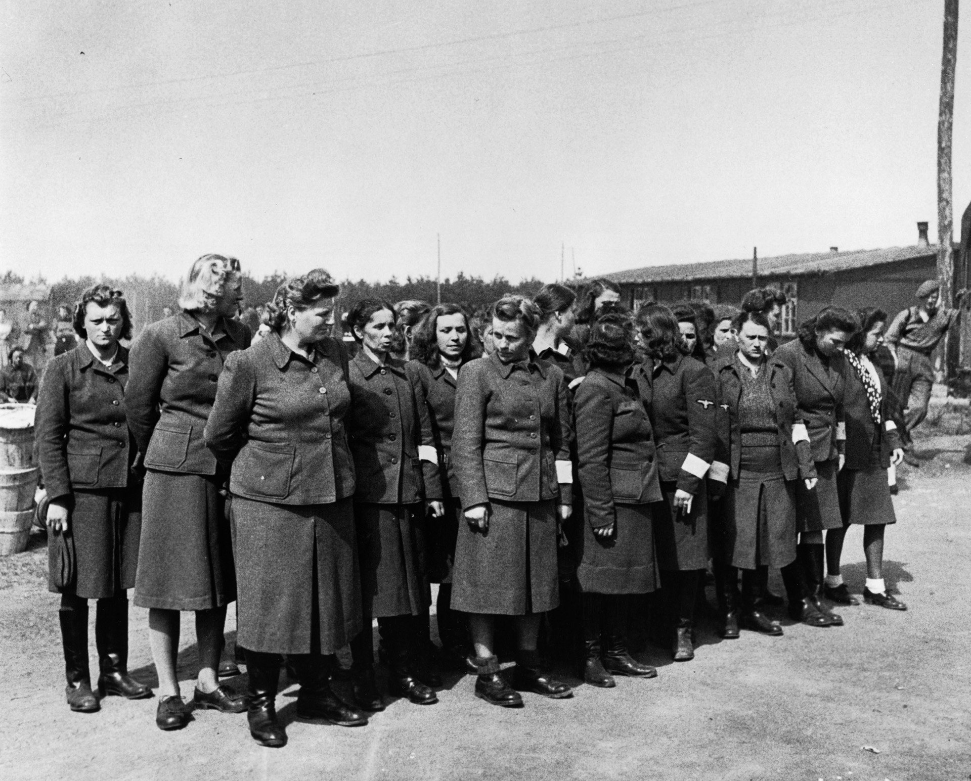 A group of female SS guards (Aufseherinnen) photographed on parade at Bergen-Belsen in 1945.