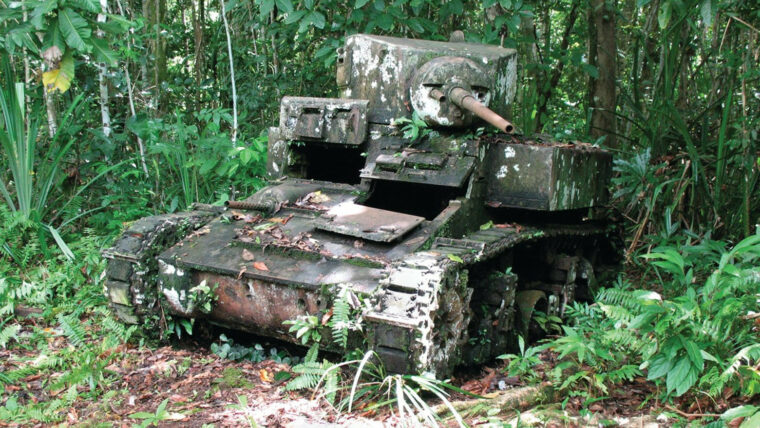The rusted hulk of an M3 Stuart light tank is slowly being reclaimed by the jungle on the edge of a Bairoko Harbor village, New Georgia Island.