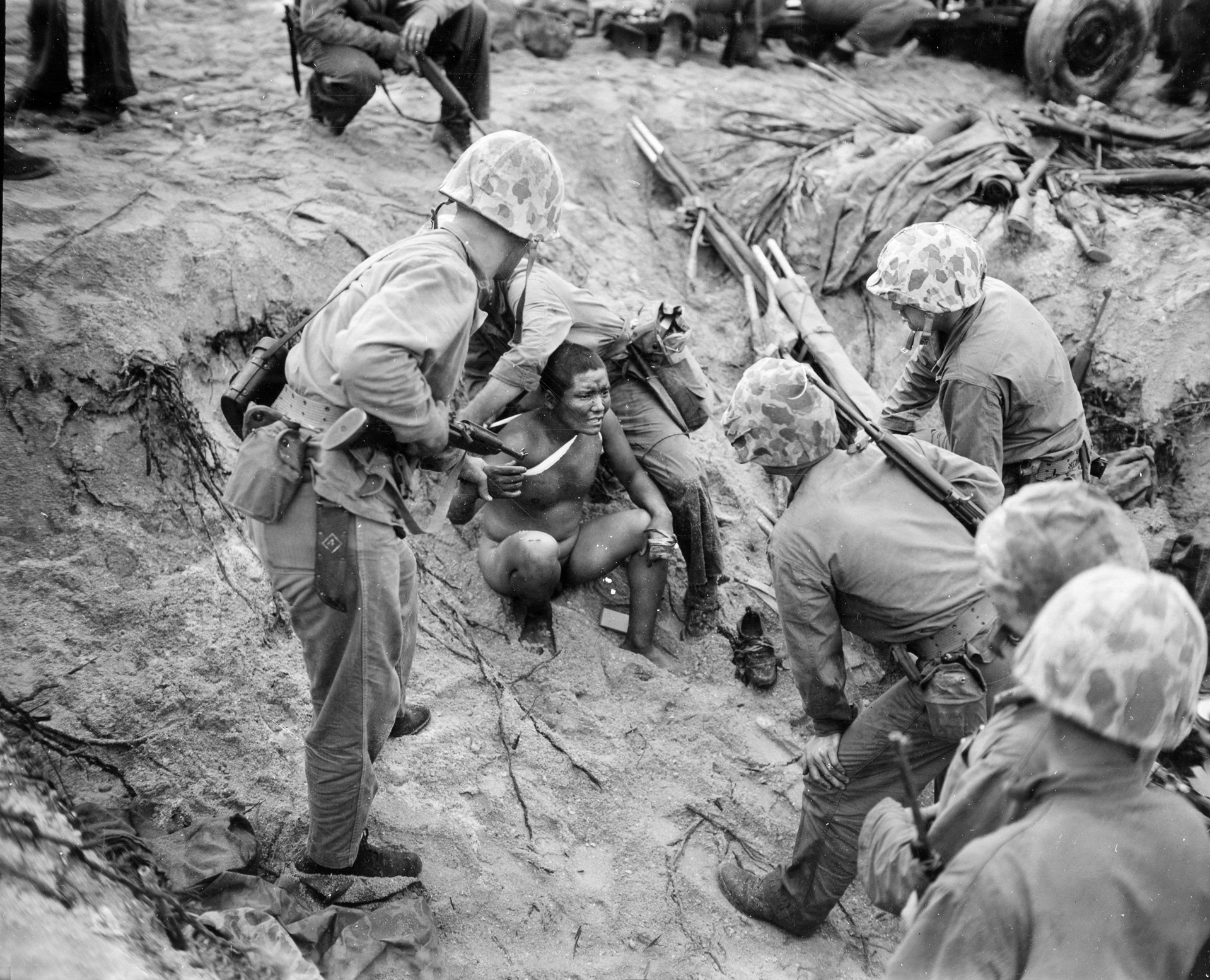 A Marine corpsman gives medical aid to a wounded Japanese soldier at Roi-Namur. By early 1944, the American juggernaut across the Central Pacific was beginning to gain momentum.