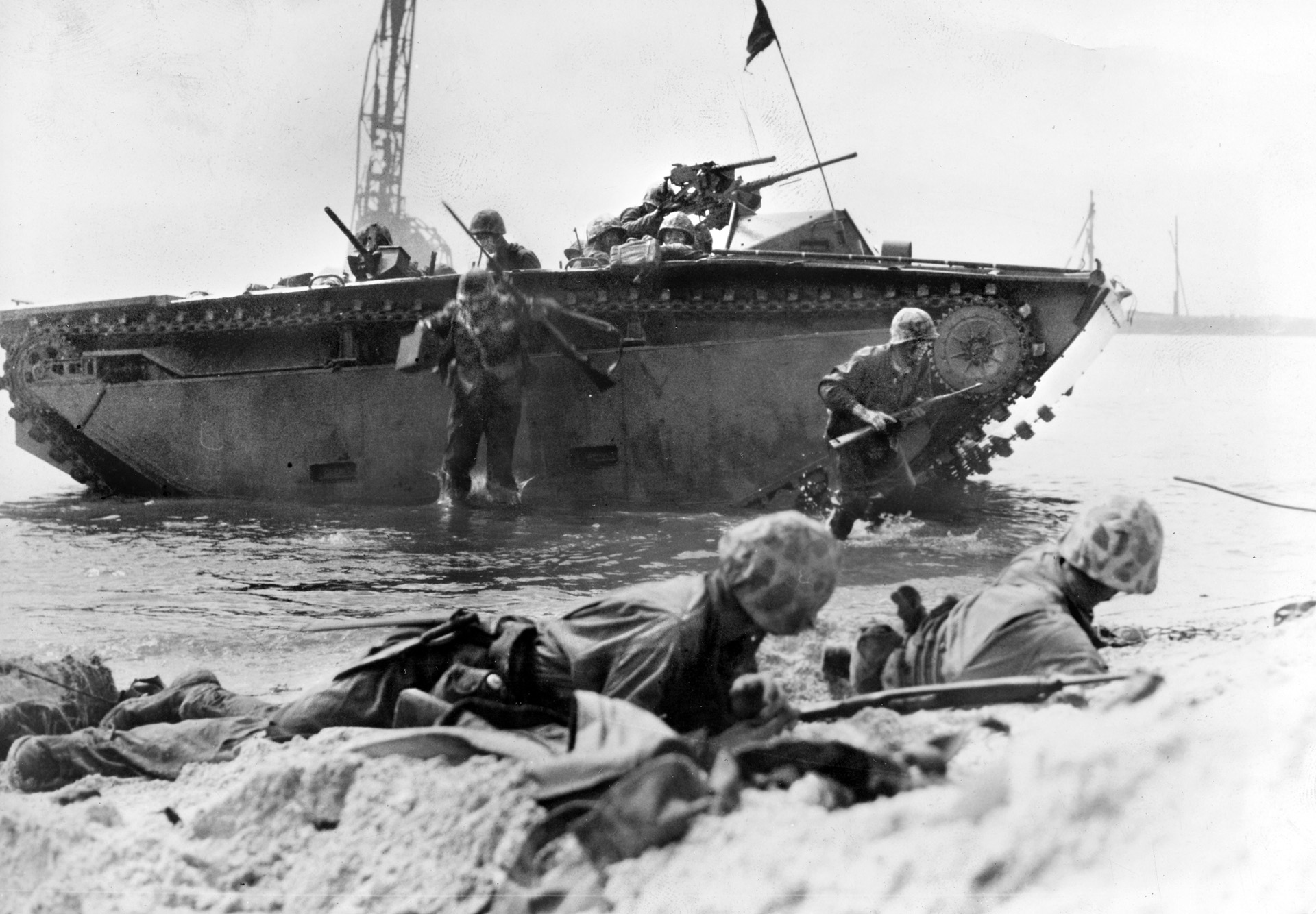 Marines leap over the side of their amphibious Amtrac landing craft during operations in the Marshall Islands. Instead of attacking the strong defenses of islands in the outer Marshalls, the Marines struck at Roi-Namur while veteran Army troops attacked Kwajalein.