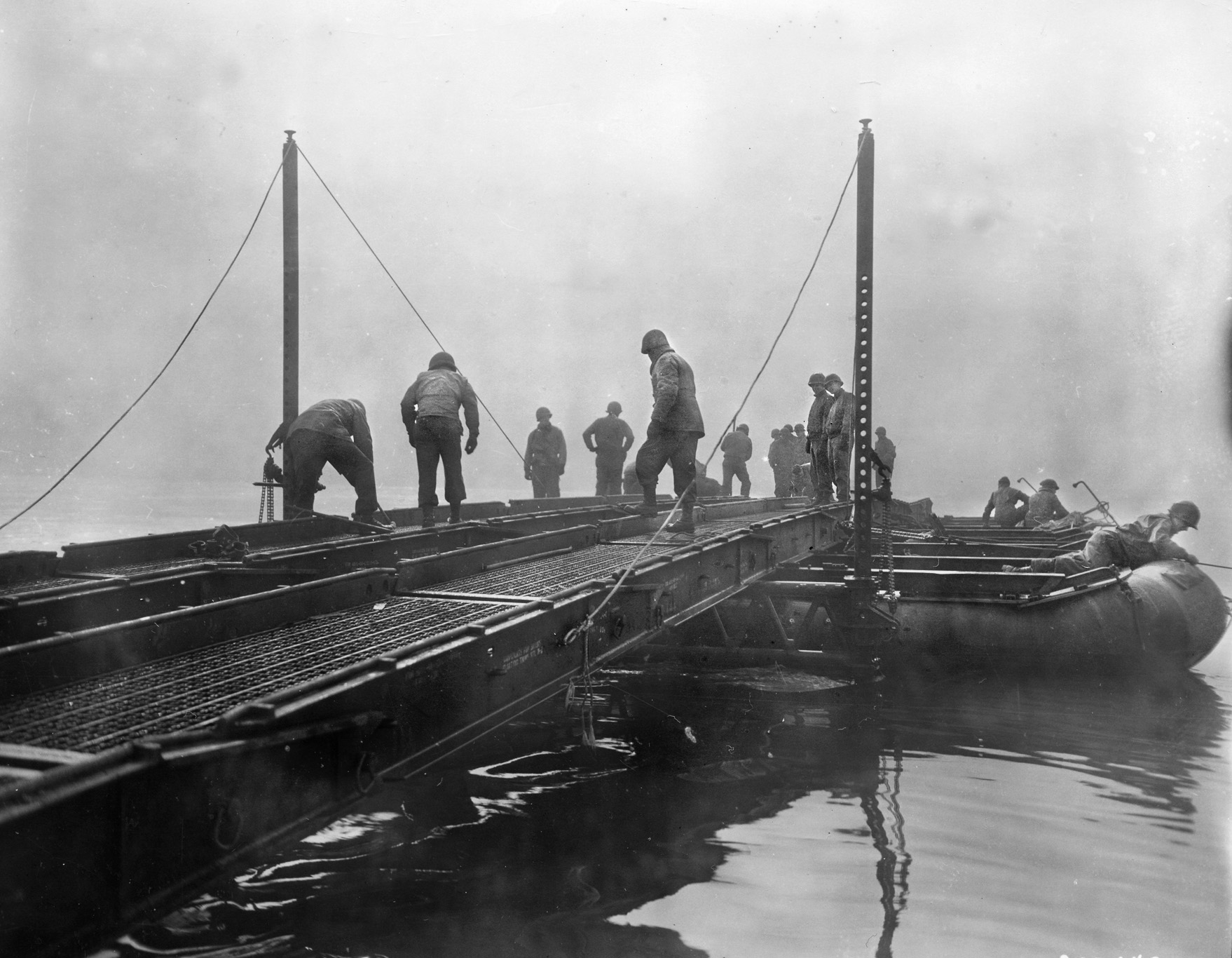 U.S. Army engineers attached to the 90th Infantry Division piece together a Treadway bridge across a German River. When a Messerschmitt fighter plane destroyed a bridge across the Werra River, Private Bernie Sevel found himself stranded on the far side. 