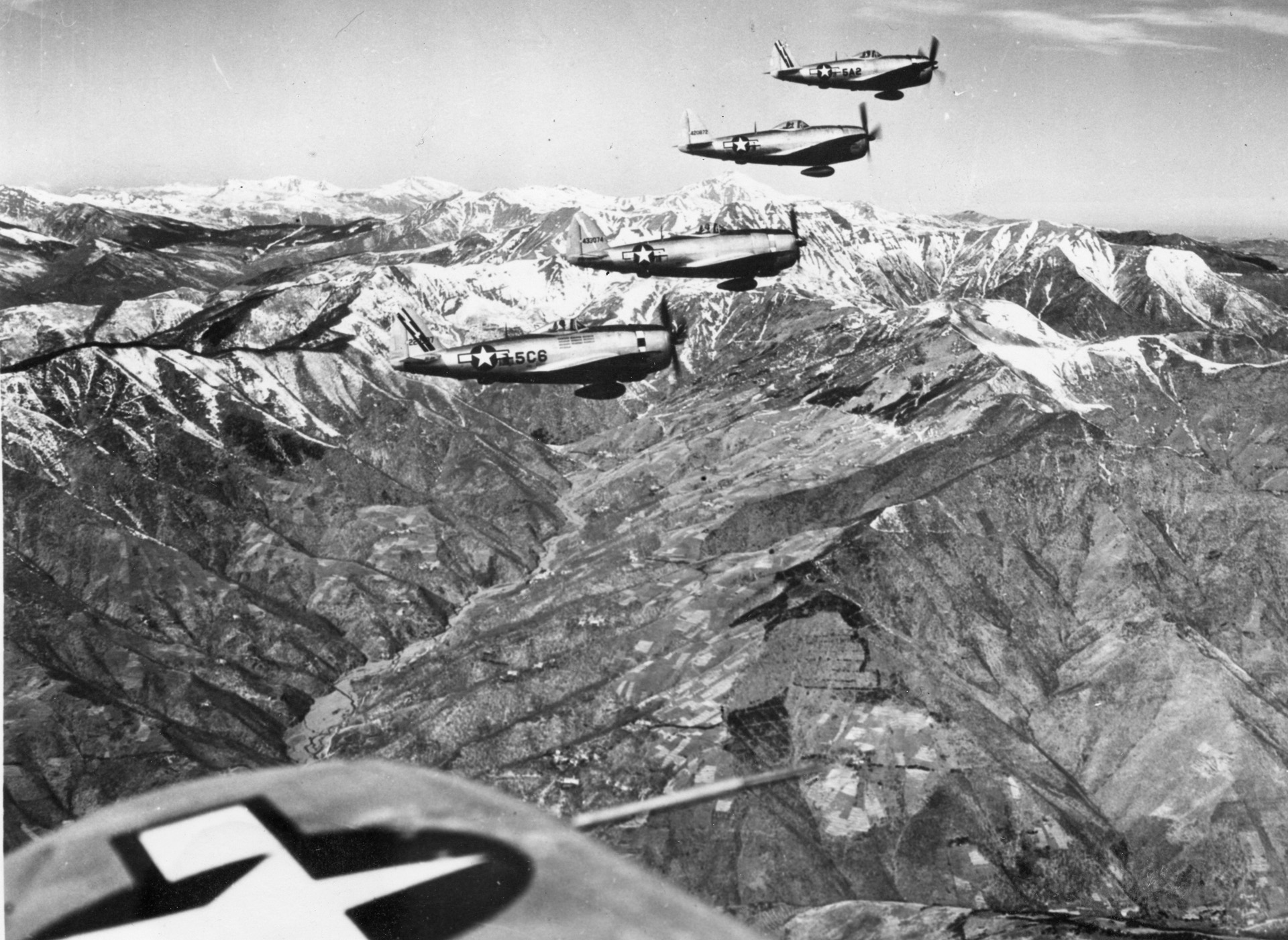 P-47 Thunderbolt fighter bombers with belly fuel tanks en route to an attack in Italy’s Northern Apennine Mountains, April 1945. OPPOSITE: P-47s, escorting a B-25 with a damaged engine returning from a 