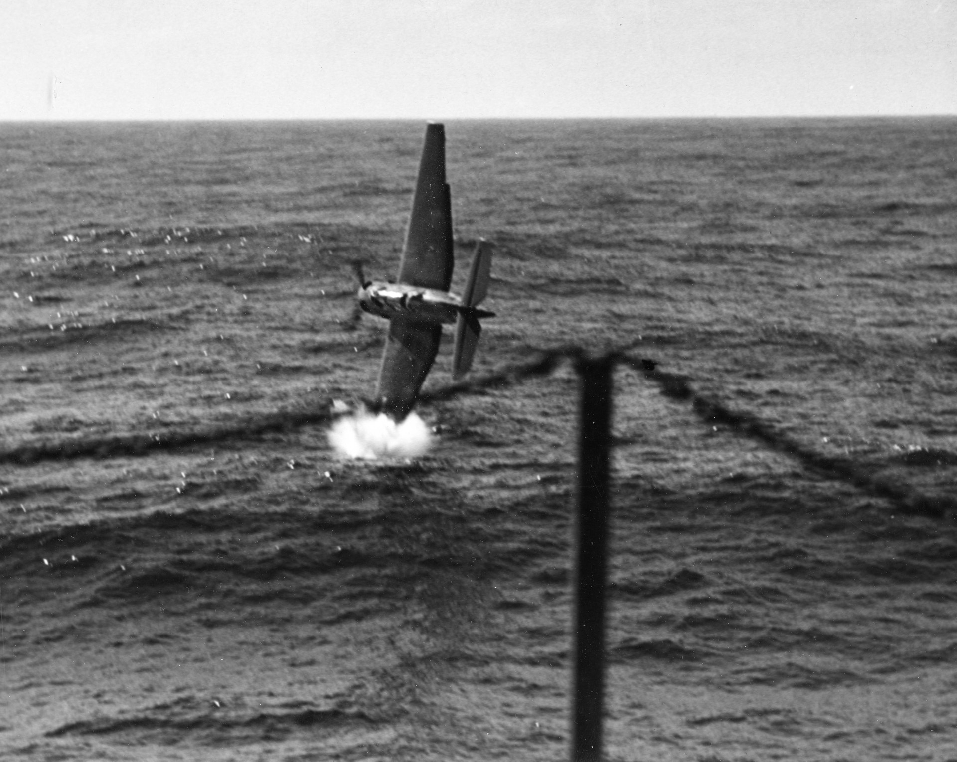After catapulting off the USS Anzio’s deck, Lieutenant B. Sevilla’s TBF drops its port wing into the ocean.