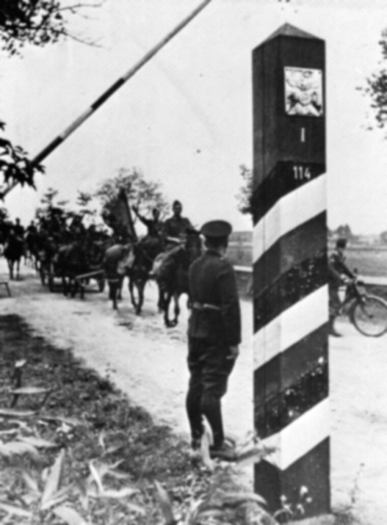 Advancing eastward, horse-drawn wagons of the Spanish Blue Division cross a checkpoint on the border between Poland and Germany.