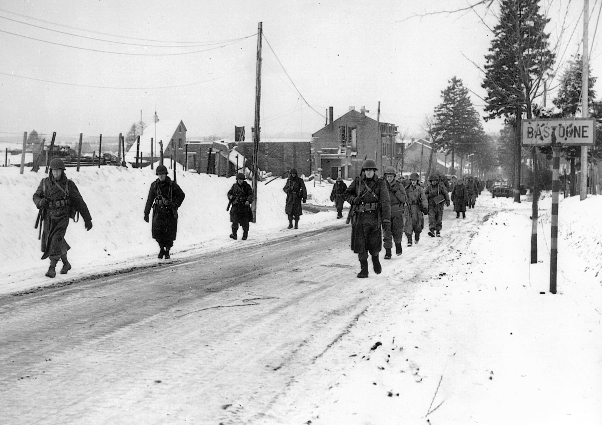 Paratroopers of the 101st Airborne Division march out of Bastogne after successfully defending  it from German attack. Don Malarkey lost numerous friends in the woods around Bastogne.  “Skip” Muck’s death haunted him for the rest of his life.