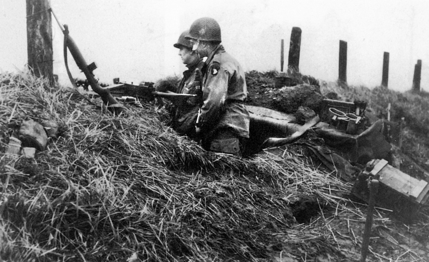 Two Easy Company paratroopers patrol the dikes of Holland. Malarkey pulled British tankers out of a stricken tank and fended off a German tank with mortar rounds while defending “Hell’s Highway.” 