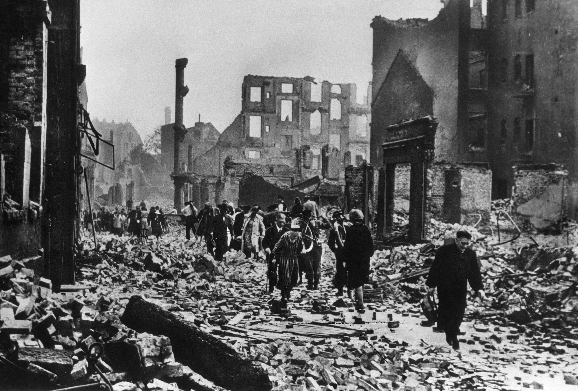 Citizens of Hamburg, Germany, pick their way through the rubble of their city during the Allies’ week-long Operation Gomorrah air raids in July 1943.