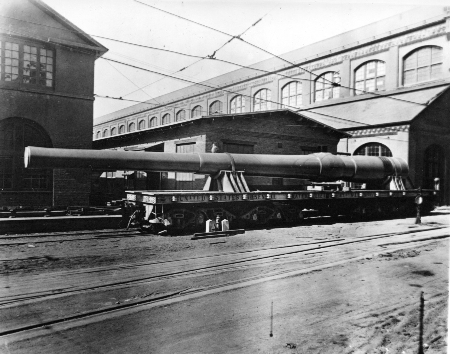 This huge 16-inch seacoast gun, produced at the Watervliet Arsenal in 1942, is placed on a rail car for transport to its final destination. Skilled craftsmen produced weapons there throughout World War II.