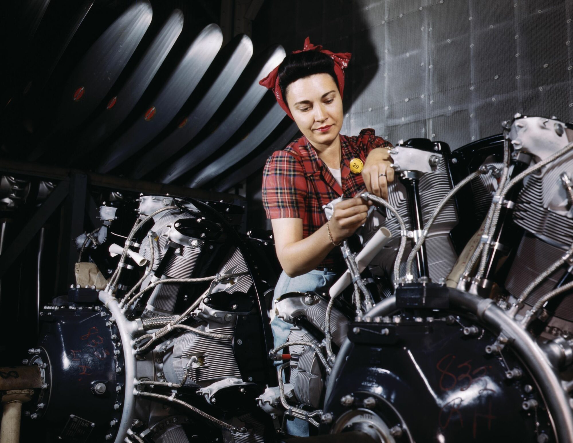 A woman works on an aircraft engine at the North American Aviation factory in Inglewood, California.