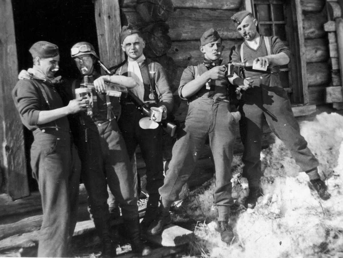 PHOTO 3: SPRING THAW ON THE EASTERN FRONT CAUSE FOR CELEBRATION: A more casual pose is taken as soldiers pour libations somewhere in Russia. To conserve resources, lace-up boots seen here replaced earlier, and more popular, full leather footwear.