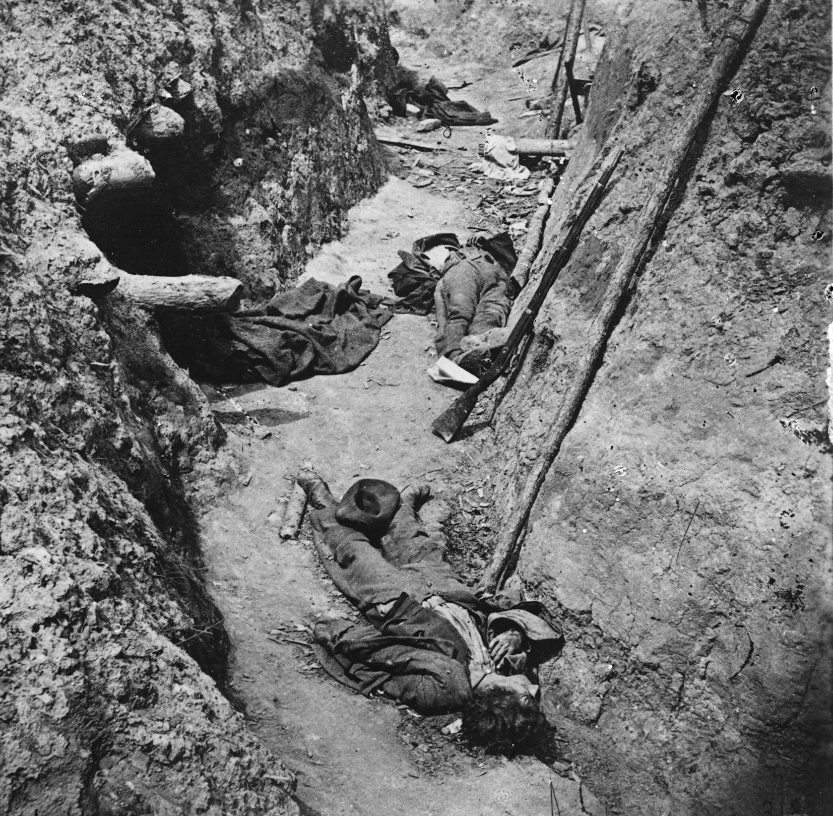 Dead Confederate soldiers lie fallen in the fetid trenches of Fort Mahone, outside Petersburg, Virginia. A former Brady associate, Thomas C. Roche, recorded the macabre image.