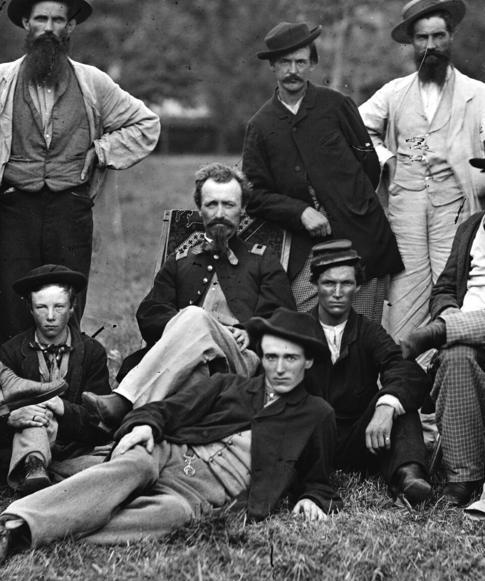 Sergeant Milton W. Cline (seated) disguised himself as a Confederate scout and reported on the location of 125 Confederate military camps and other installations during a harrowing mission behind enemy lines in winter 1863.