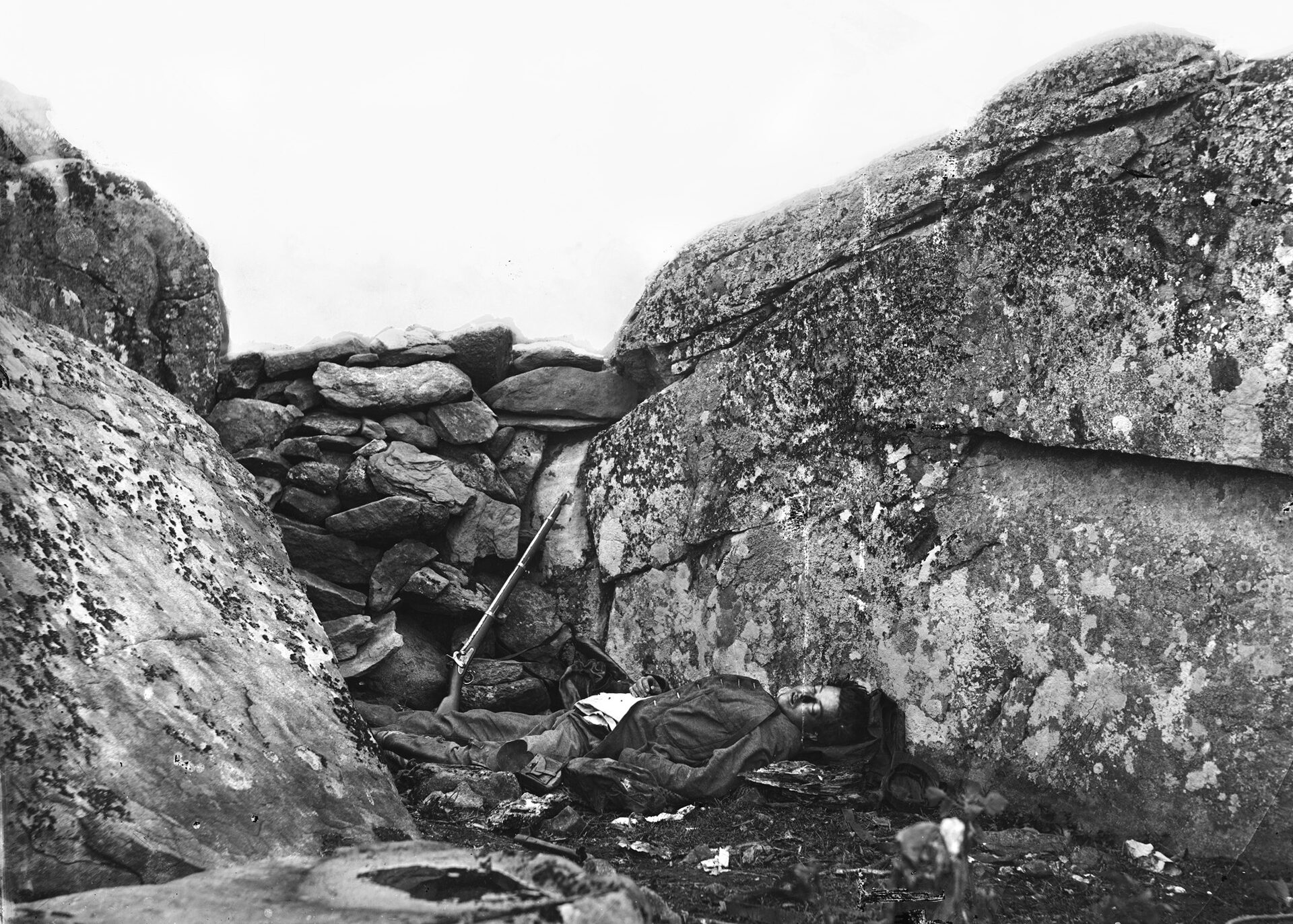 Photographers Gardner and O’Sullivan repositioned a dead Confederate soldier, a rifle, and a knapsack to create the tableau of an alleged “sharpshooter” at Gettysburg’s Devil’s Den.