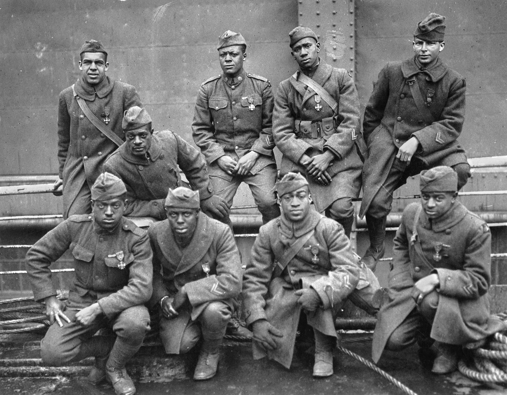 Group portrait of bravery. African American soldiers of the 369th Regiment (a New York element attached to the French Army) who were awarded the Croix de Guerre for gallantry in action in France in World War I. (L. to R., front row): Ed Williams, Herbert Taylor, Leon Fraitor, Ralph Hawkins. (Back row): H.D. Prinas, Dan Stroms, Joe Williams, Alfred Hanley, T.W. Taylor.