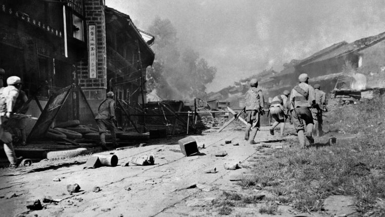 May 1944: Chinese troops advance through the streets of the ancient city of Tengchung, held by the Japanese for two years. The Japanese garrison at Tengchung was wiped out.