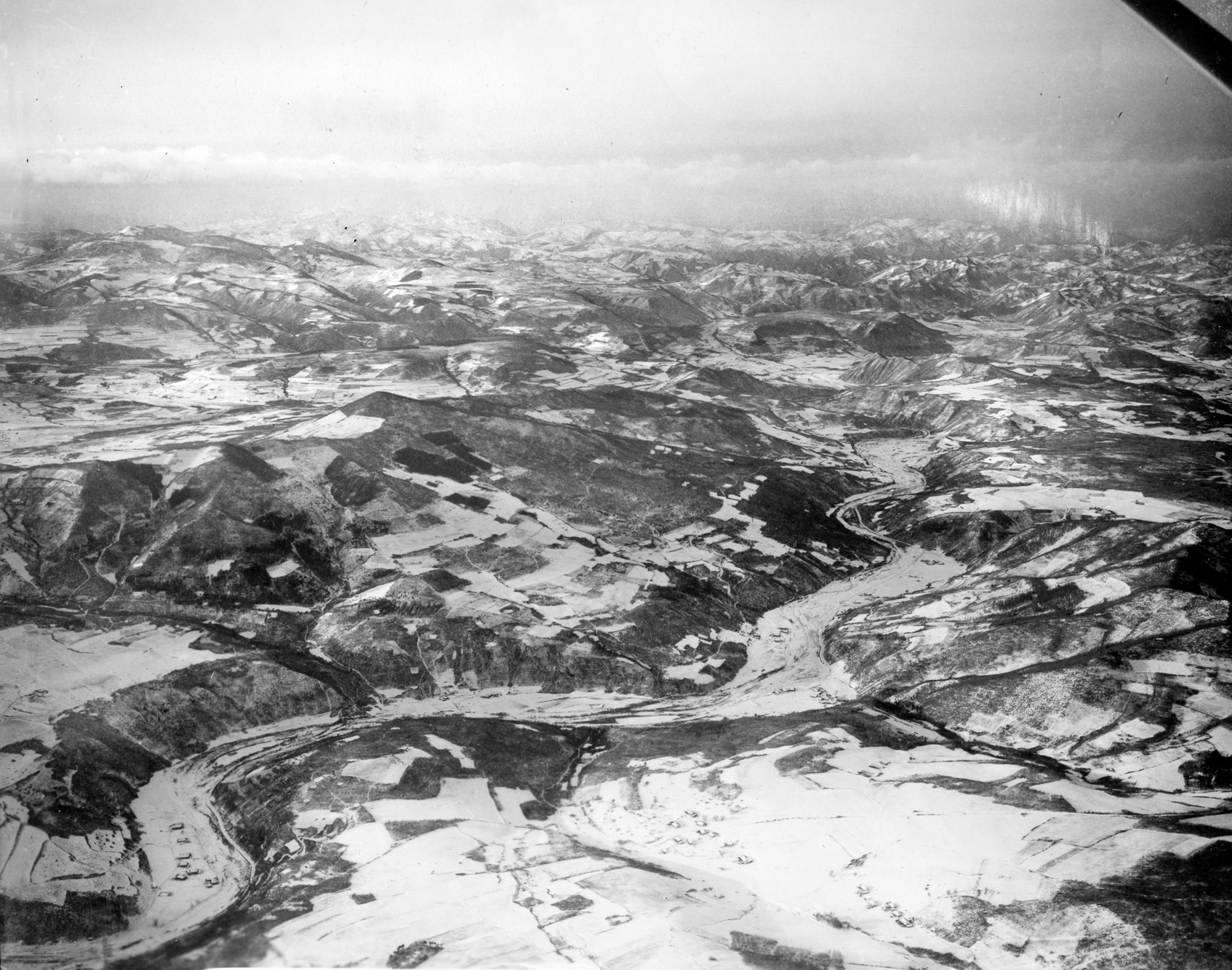 The rugged, unforgiving terrain of North Korea along the Chinese border is evident in this aerial shot taken shortly before the attack of the Chinese Communist Forces. The Chinese victory at the Chosin Reservoir came at a heavy cost in casualties from human wave attacks.