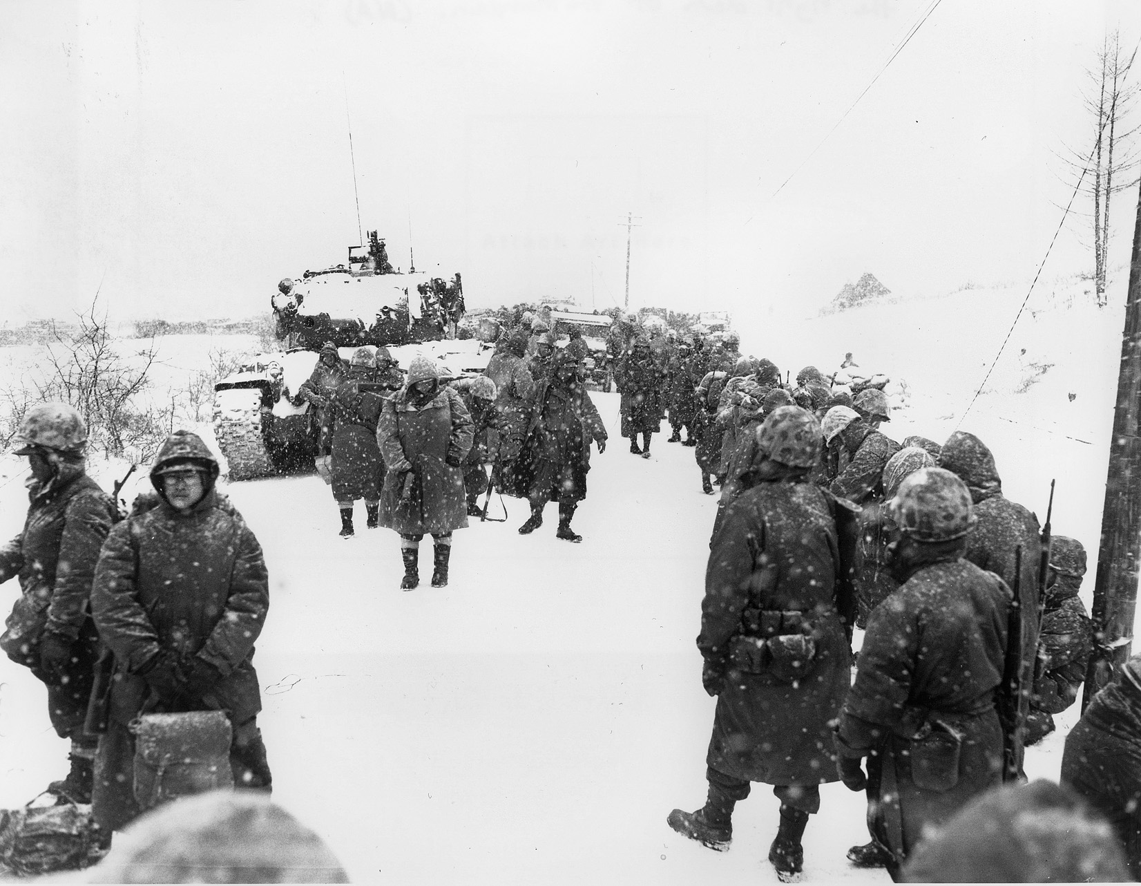U.S. Marines suffering from exposure to freezing weather retreat from their advanced positions at the Chosin Reservoir.