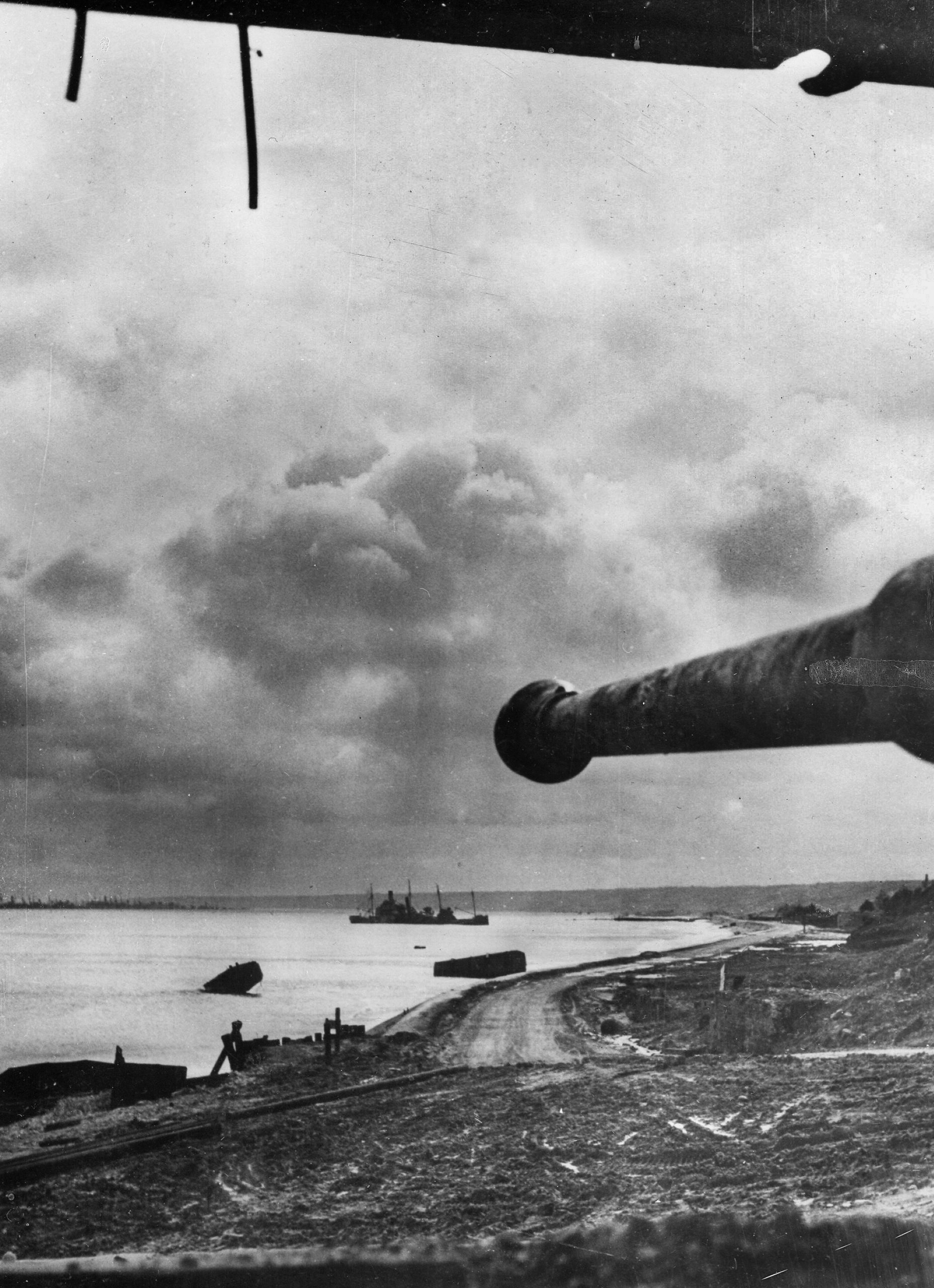 The mute barrel of an 88mm gun overlooks the Dog Green sector of Omaha Beach. The gun emplacement became a memorial to the U.S. National Guard.