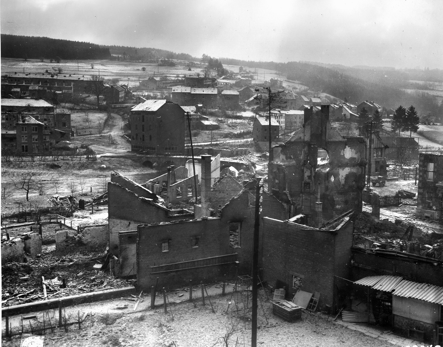 The shattered Belgian town of Stavelot is shown during the Battle of the Bulge. In the center at left is the bridge over the Ambléve River. 