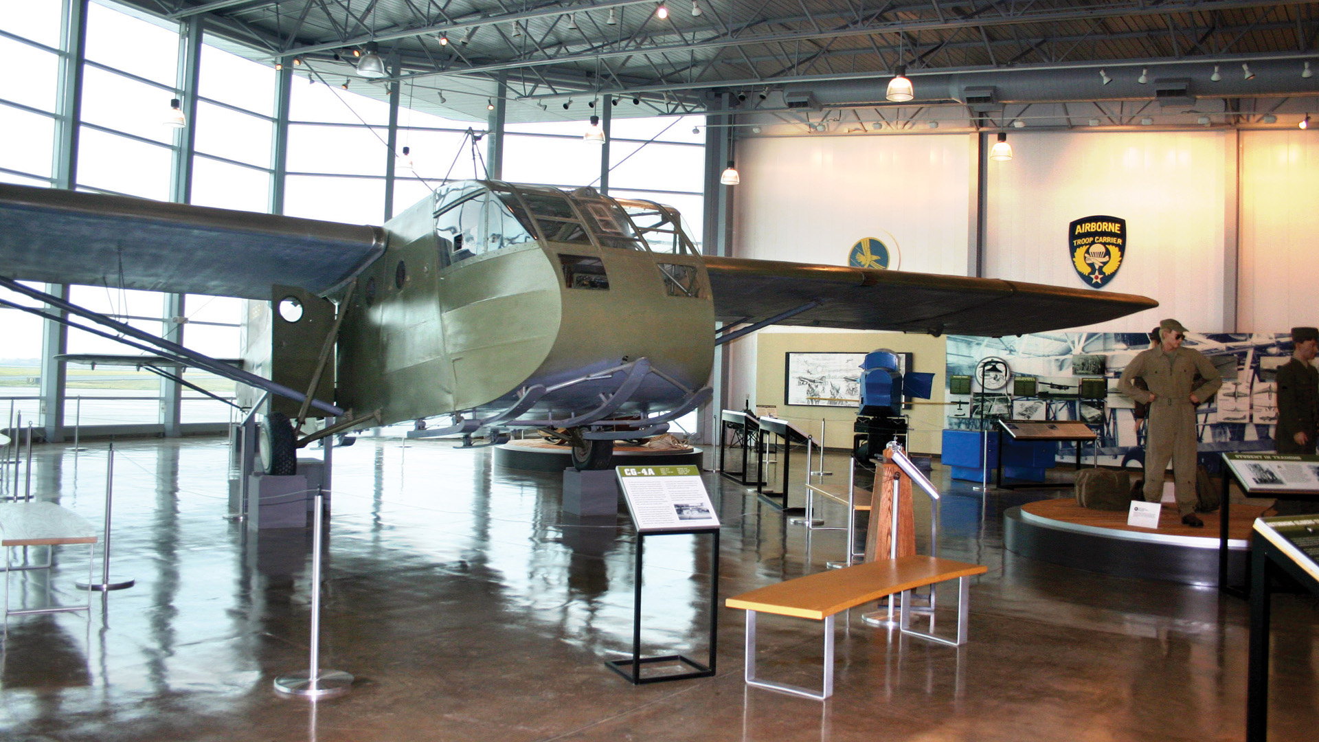 Interior of the spacious main hall of the Silent Wings Museum with its centerpiece—a restored Waco CG-4A glider—on display.