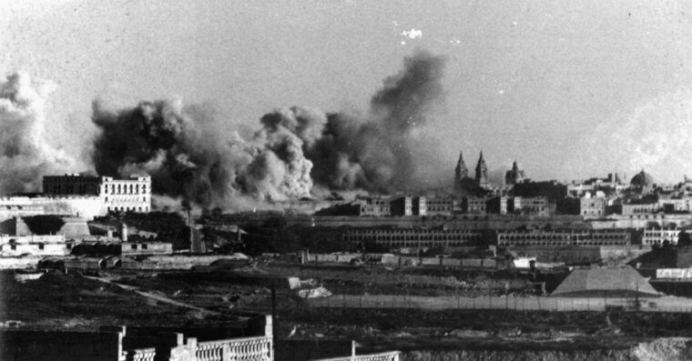 Explosions rock Malta during an enemy air raid. Due to Malta’s location along German and Italian supply routes, its airfields and dockyards were subject to many bombing runs.