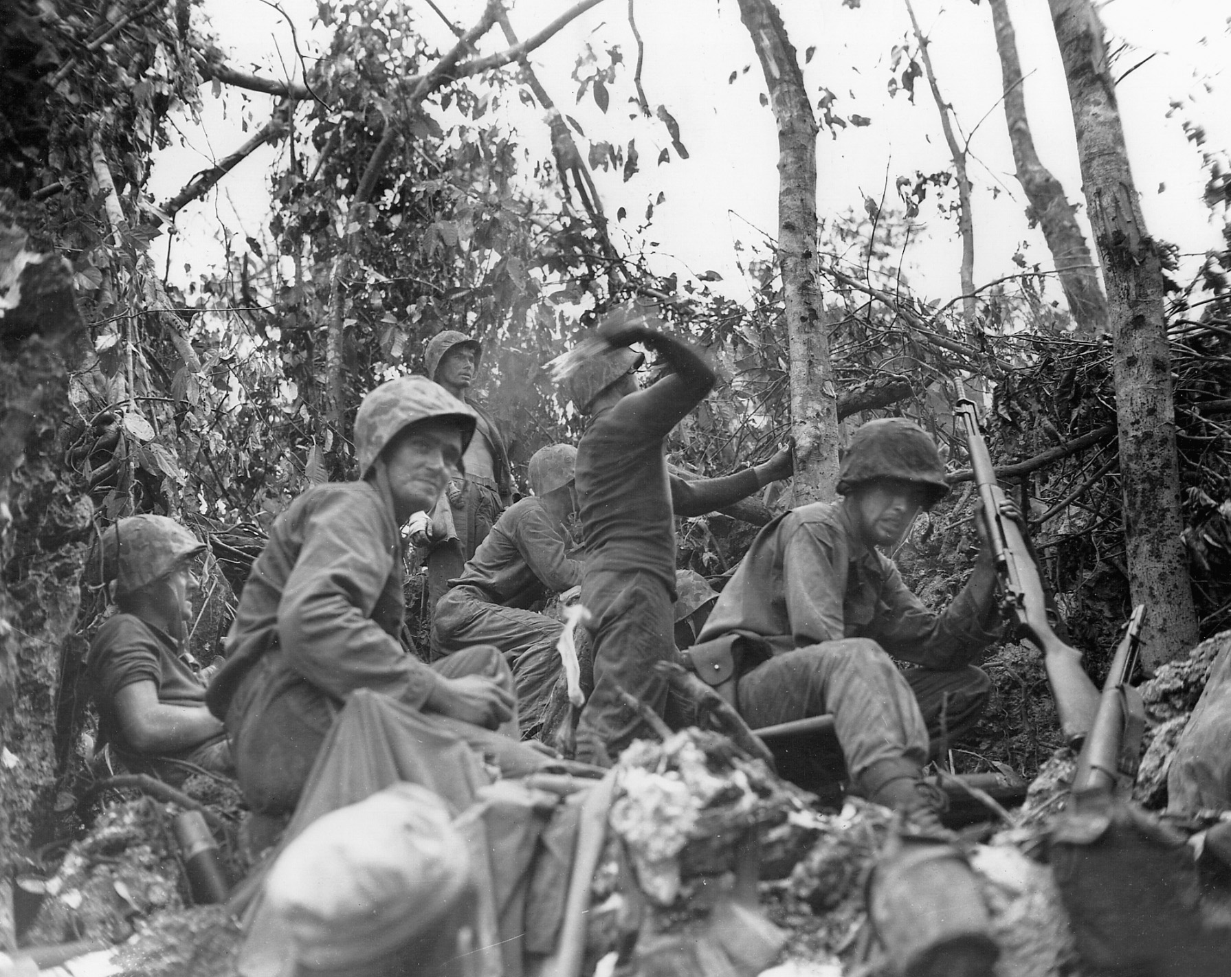 During one of many close quarters engagements in the dense jungle of Peleliu, Marines hurl molotov cocktails towards enemy positions along a bitterly contested elevation nicknamed “Suicide Ridge.”