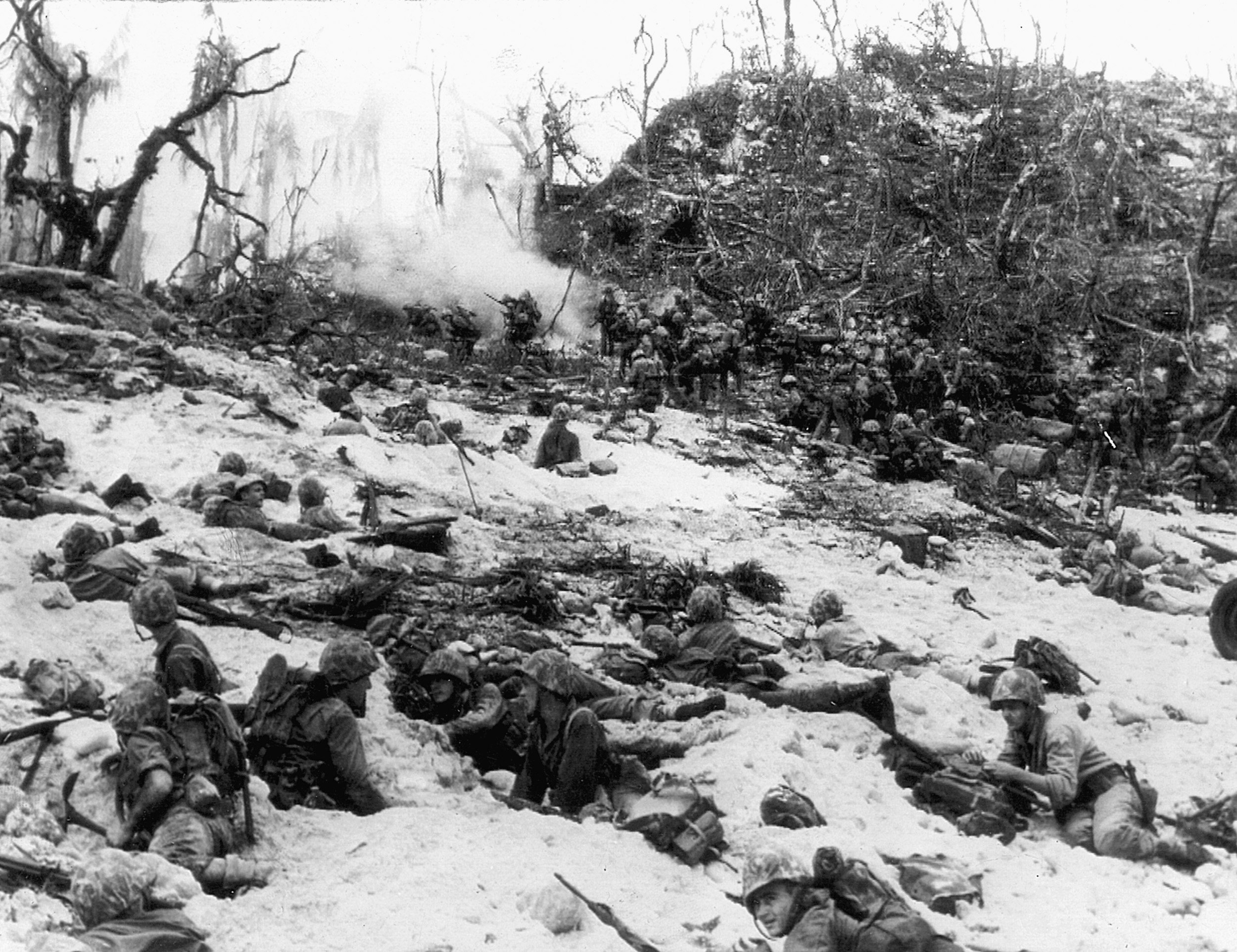 Under heavy fire from an underestimated enemy, Marines of the 1st Division dig in and await orders to move forward.