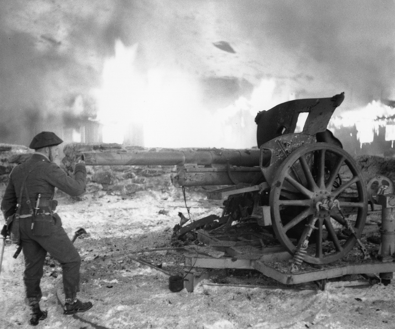 Churchill inspects the wreckage of a German field gun following action against elements of the Wehrmacht in France.