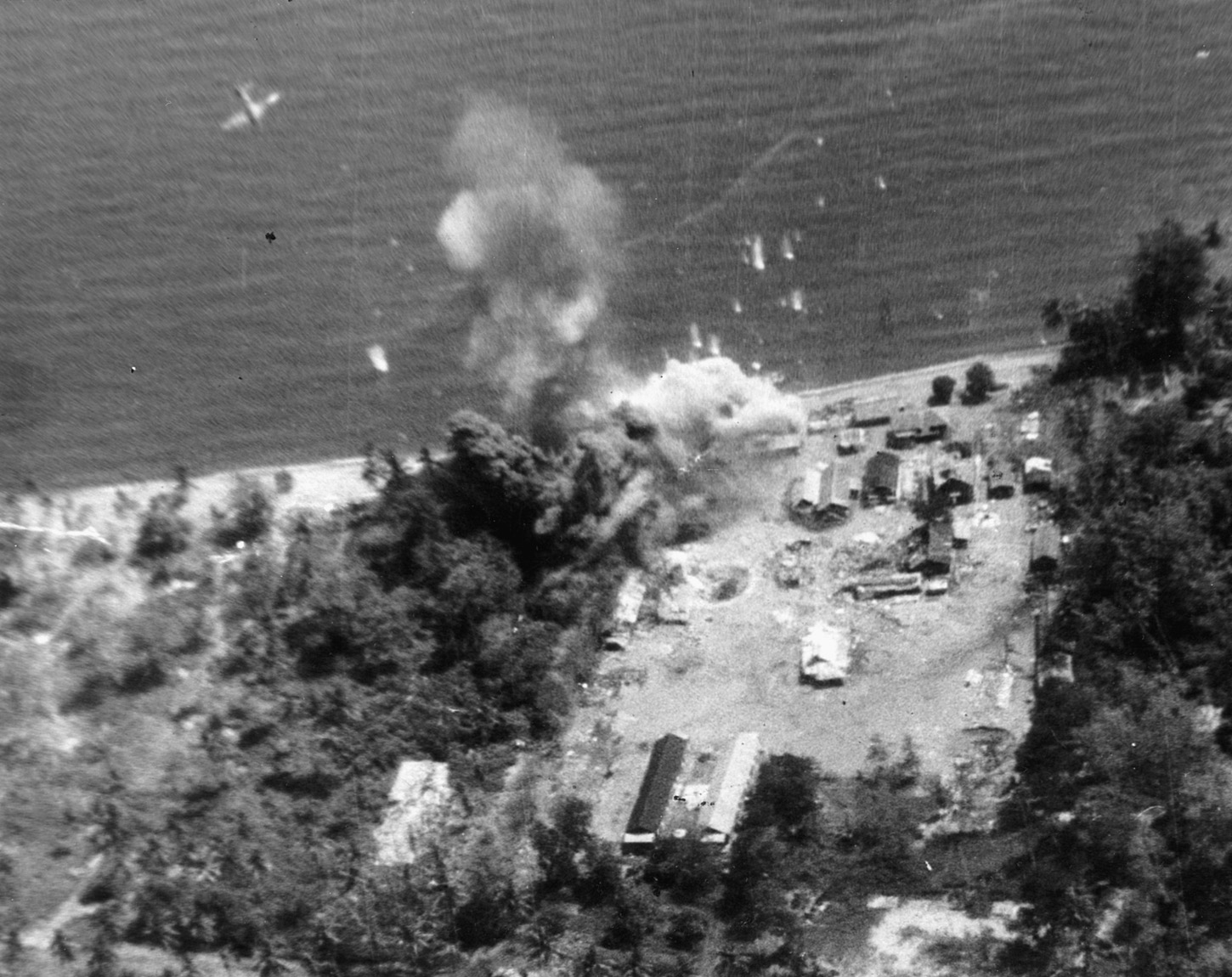 A U.S. Marine Corps dive-bomber scores a direct hit on a Japanese oil tanker near Rabaul in July of 1944.
